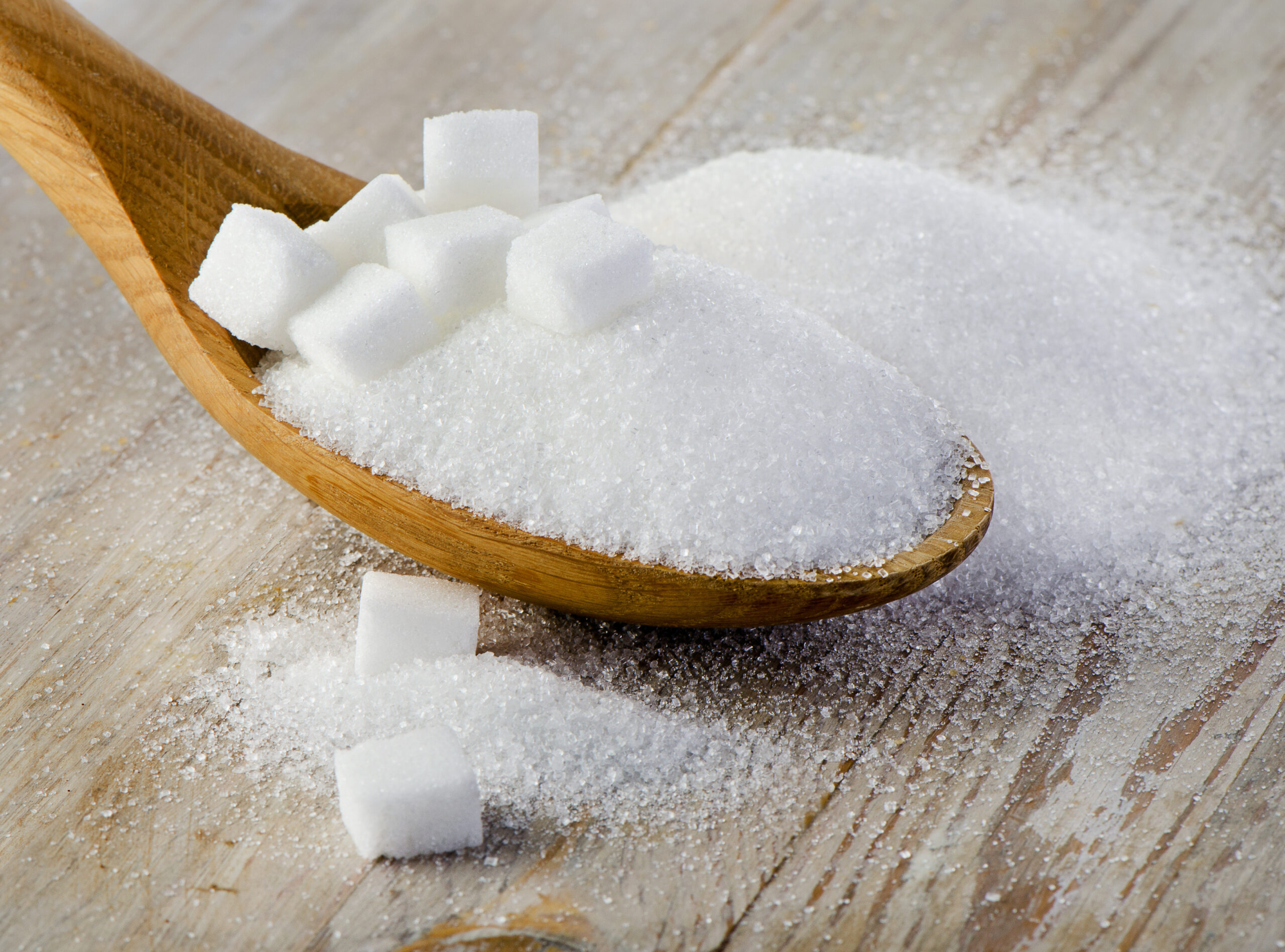 Sugar on wooden table. Selective focus