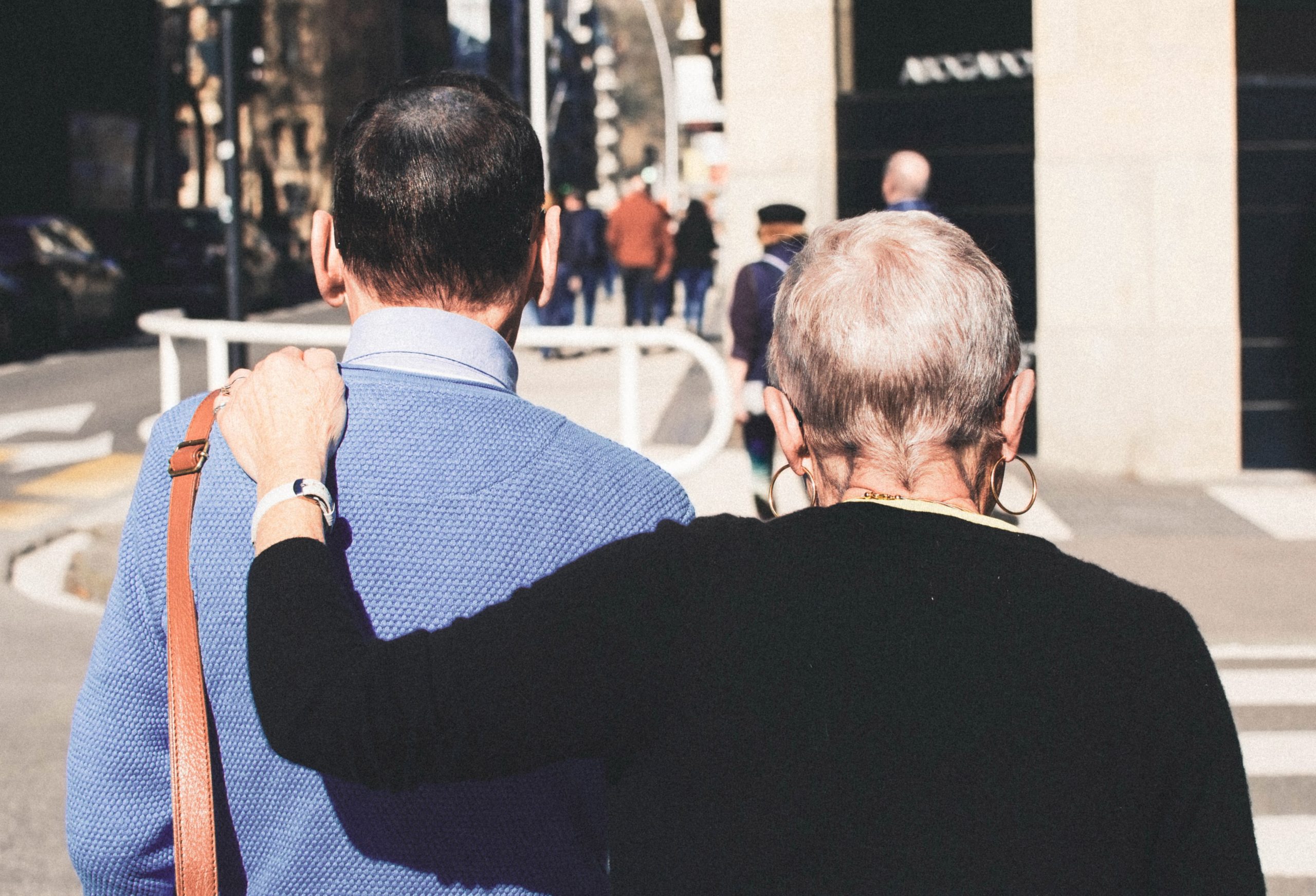 Senior holding the shoulder of man to support each other