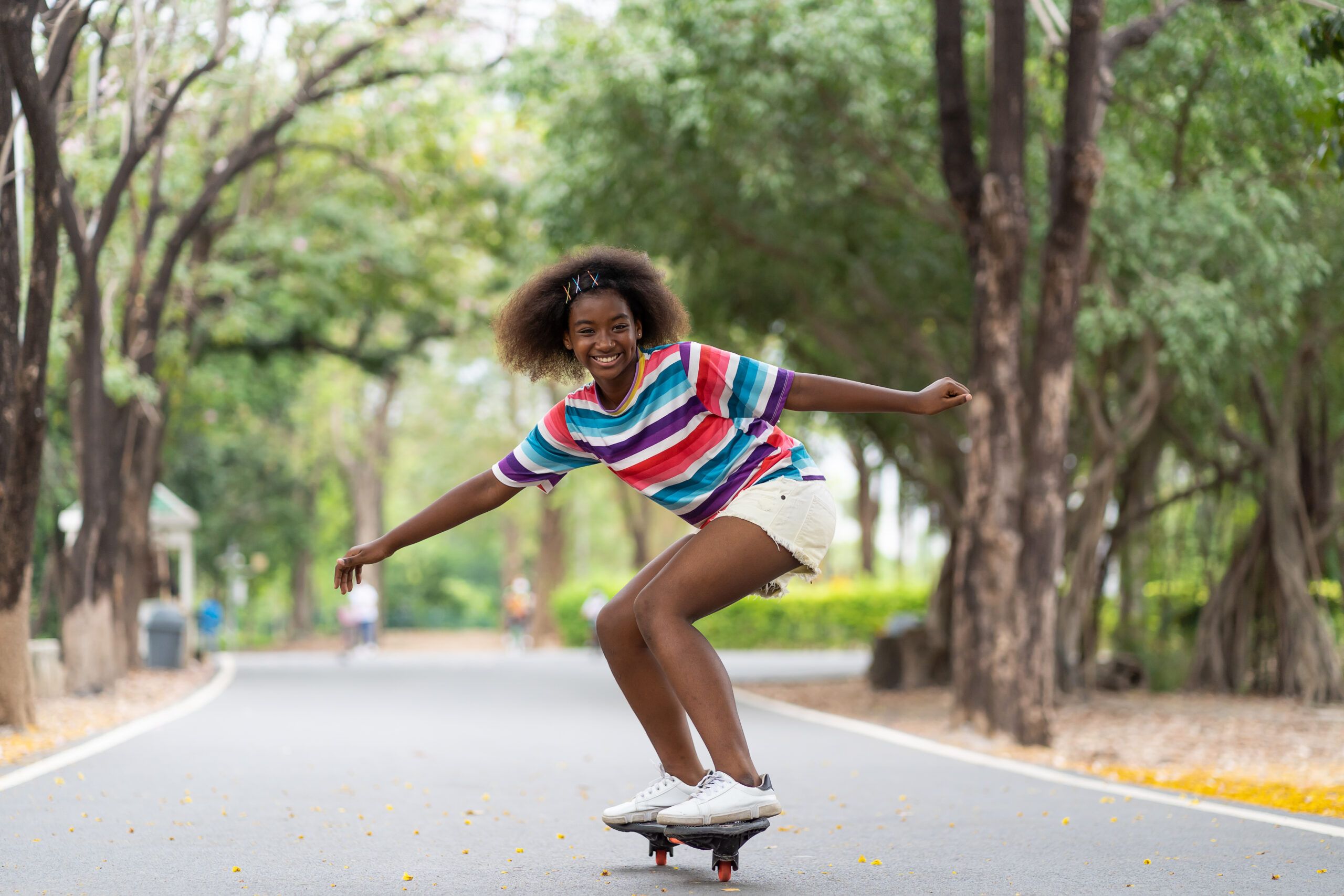 teenage girl skateboarding in neighbourhood