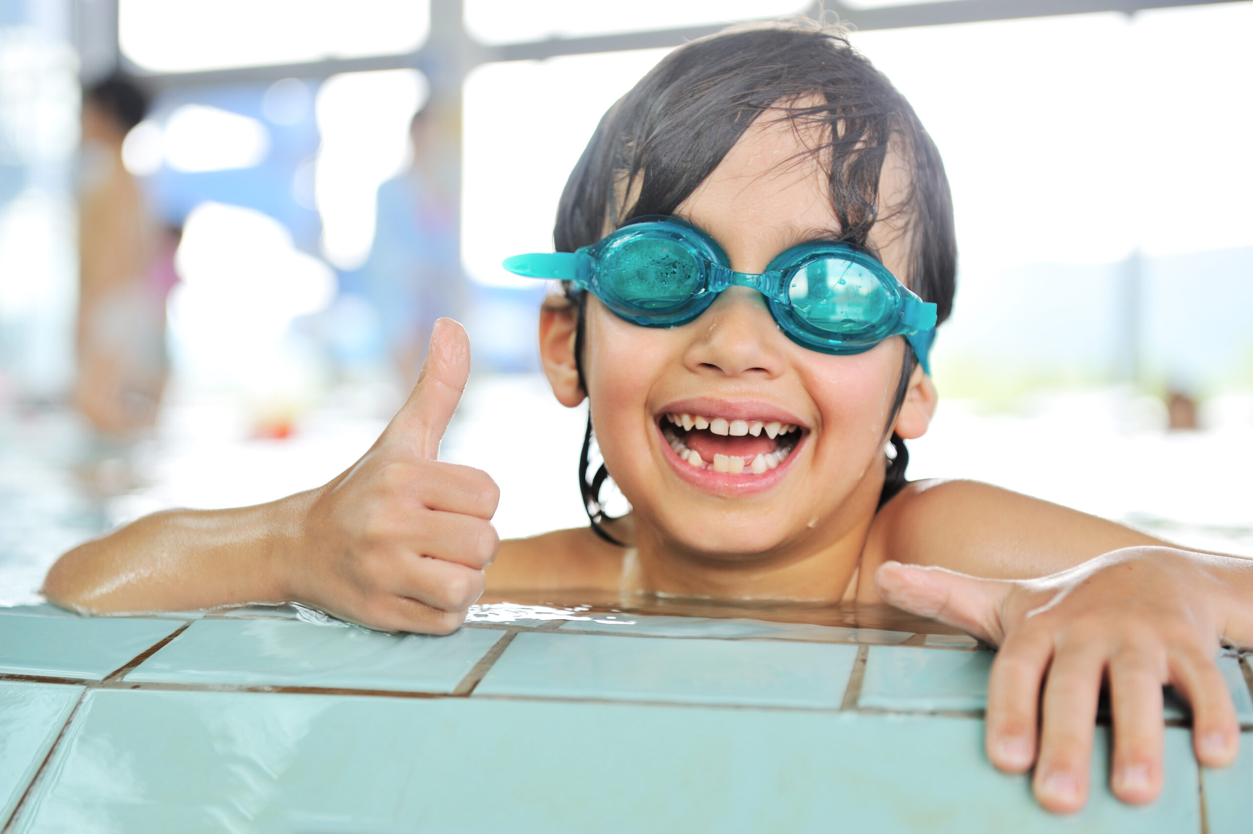 Summertime and swimming activities for happy children on the pool